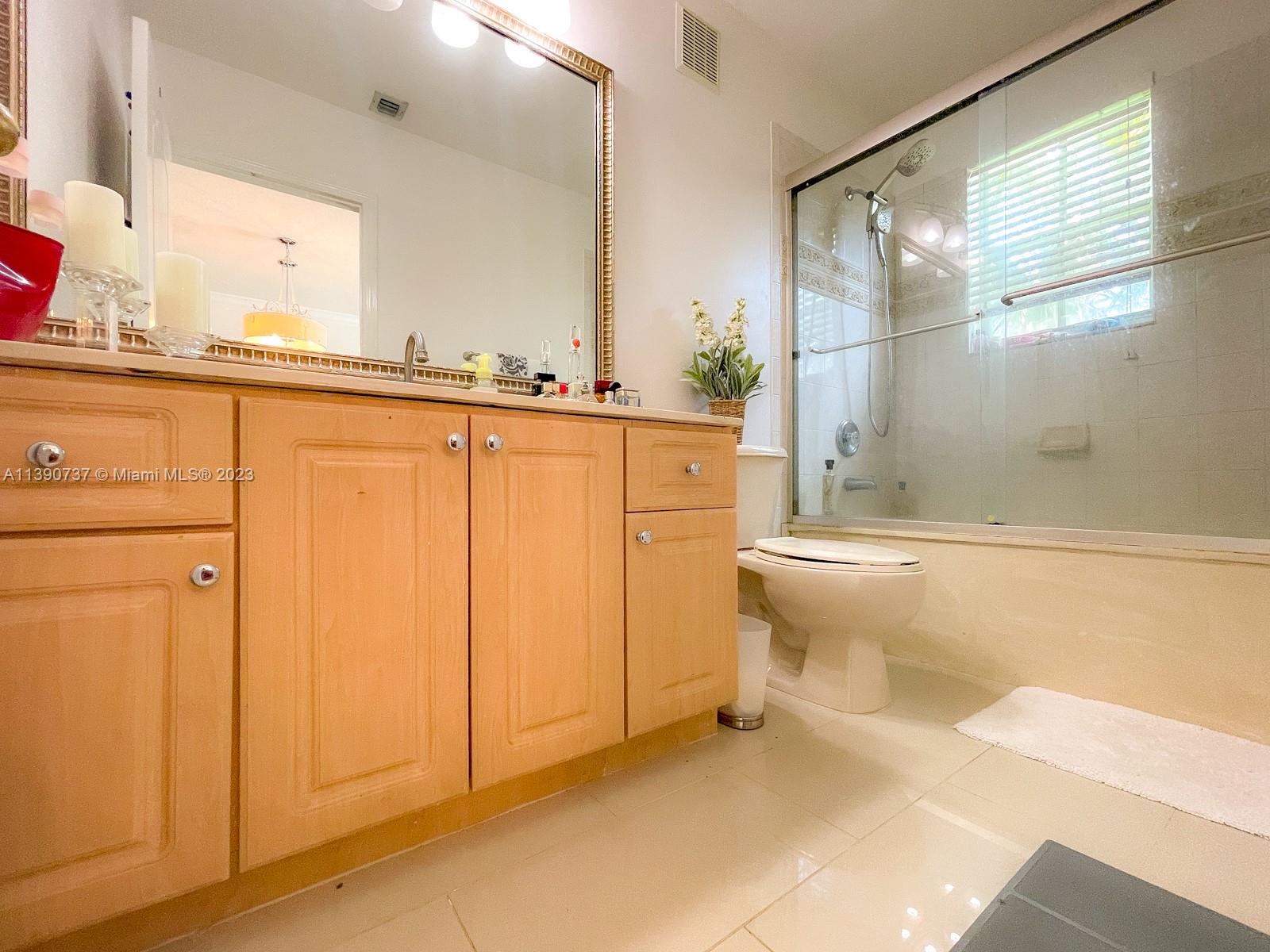 3136 Southwest 129th Way, Unit 157 Miramar, FL 33027 - Photo 13 of 23 a bathroom with a bathtub and a shower