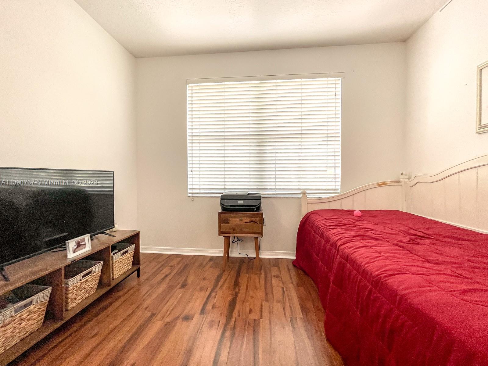 3136 Southwest 129th Way, Unit 157 Miramar, FL 33027 - Photo 15 of 23 a bedroom with a bed and a flat screen tv