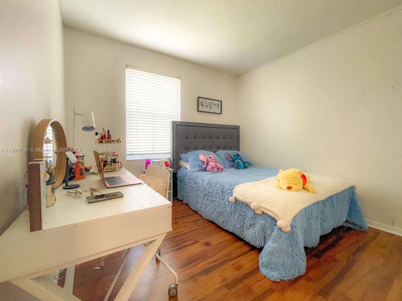 3136 Southwest 129th Way, Unit 157 Miramar, FL 33027 - Photo 17 of 23 a bedroom with a bed and a dresser