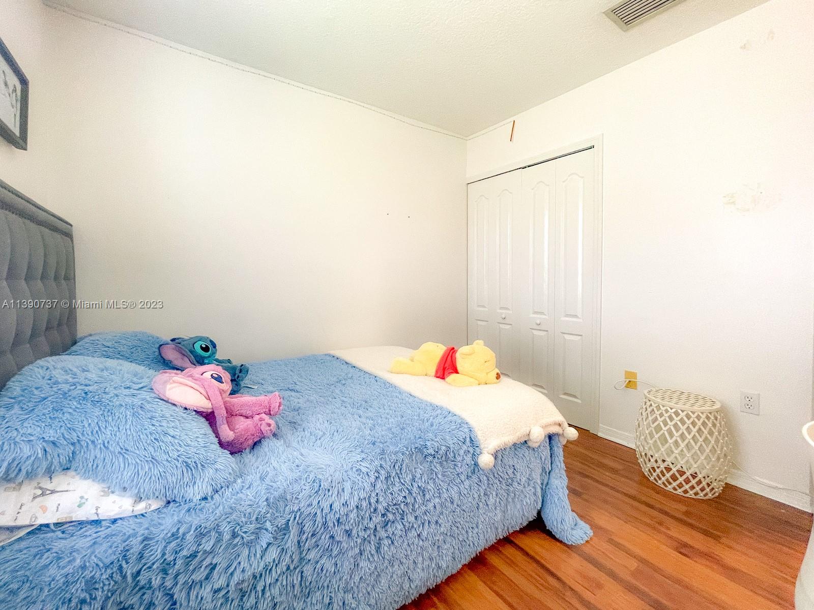 3136 Southwest 129th Way, Unit 157 Miramar, FL 33027 - Photo 18 of 23 a bedroom with a bed and a window