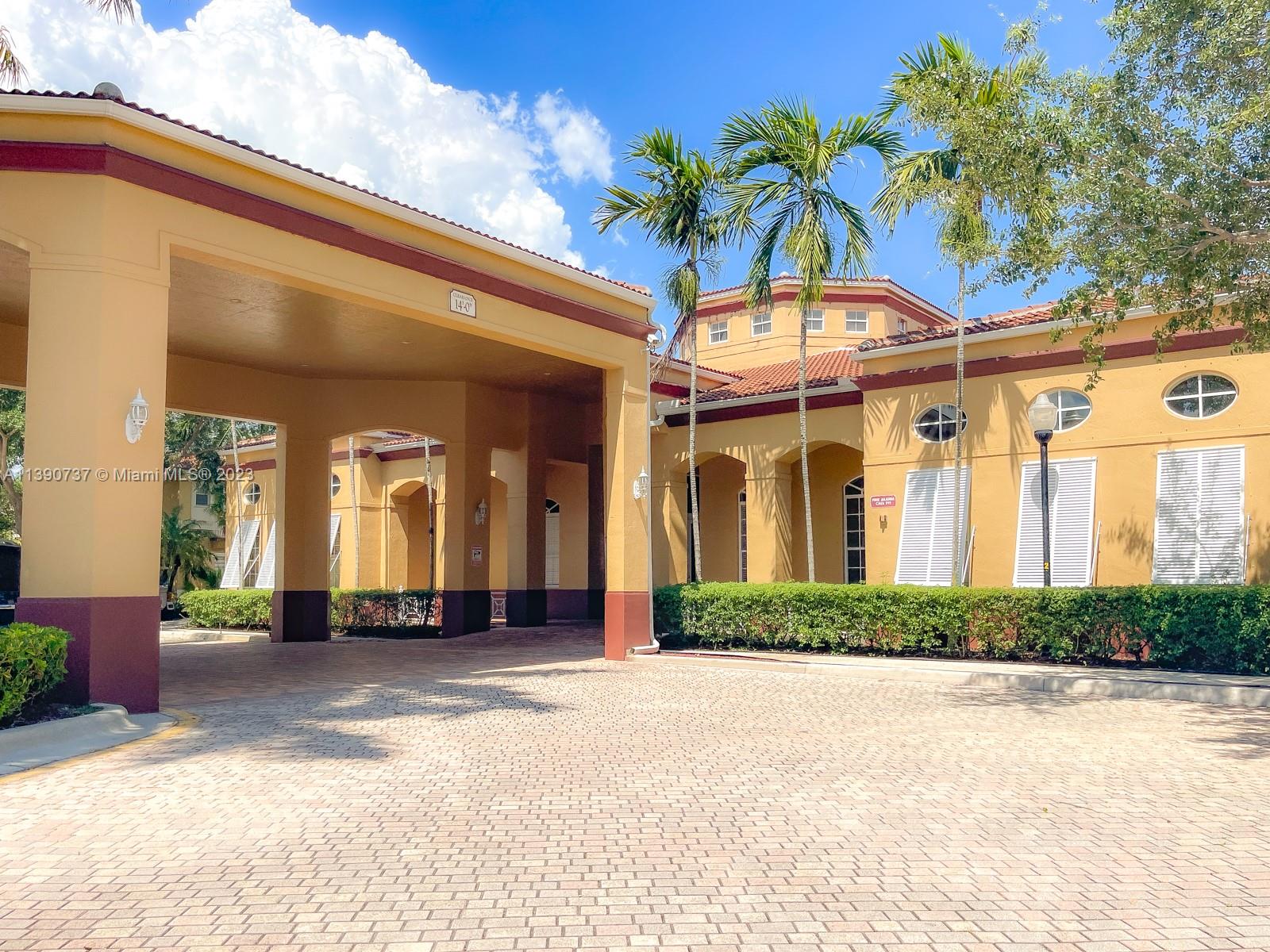 3136 Southwest 129th Way, Unit 157 Miramar, FL 33027 - Photo 19 of 23 a view of a building with a garden