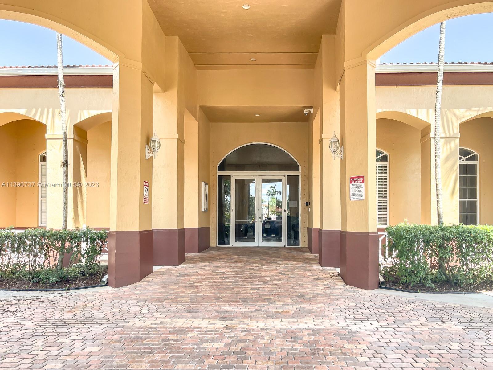 3136 Southwest 129th Way, Unit 157 Miramar, FL 33027 - Photo 20 of 23 a view of a brick house with a porch
