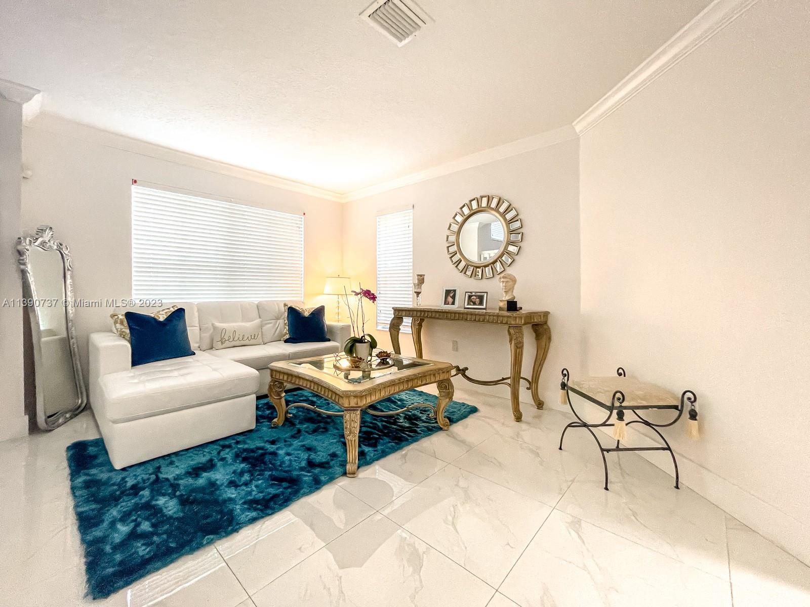 3136 Southwest 129th Way, Unit 157 Miramar, FL 33027 - Photo 2 of 23 a living room with furniture and a large window