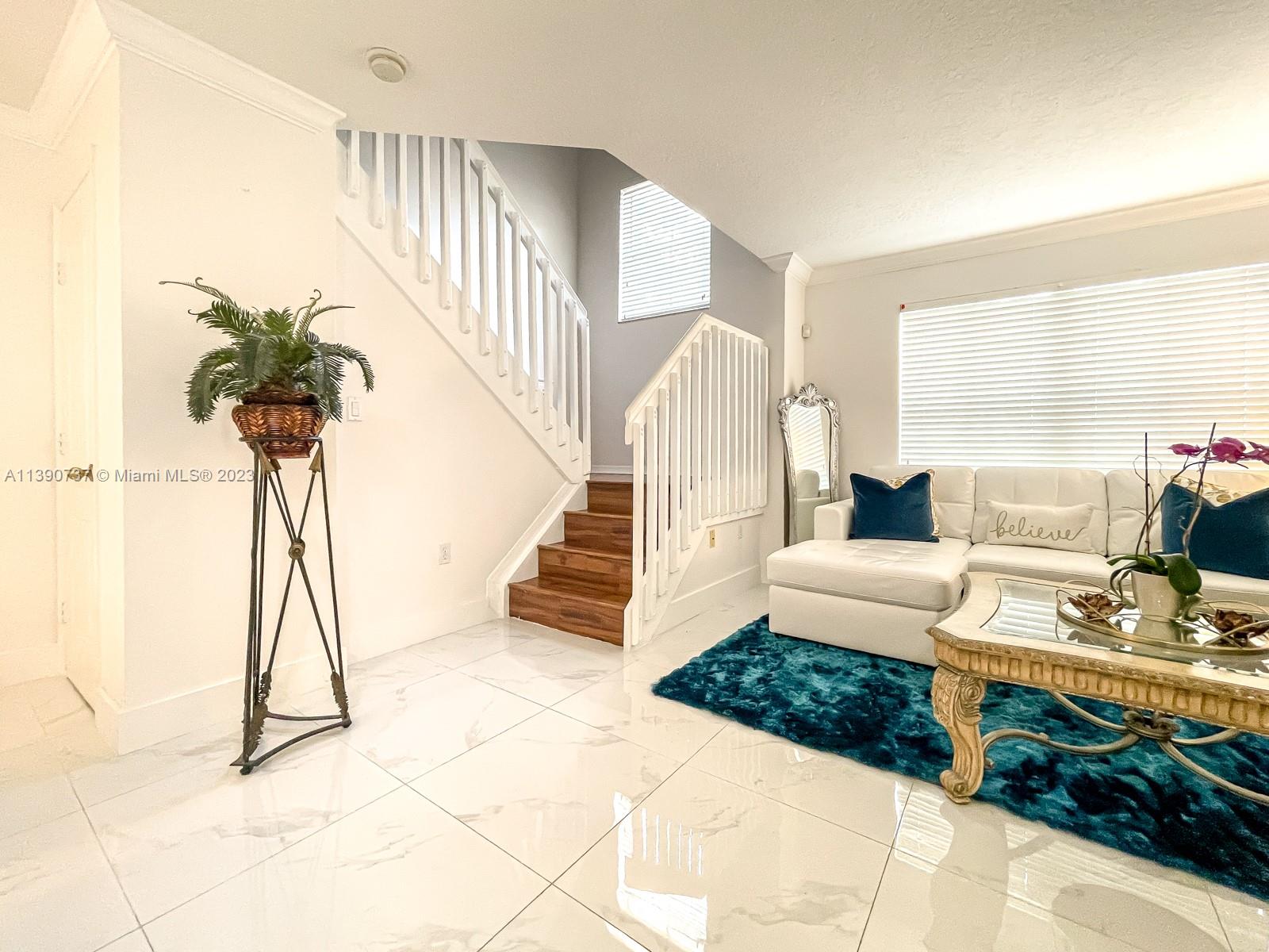 3136 Southwest 129th Way, Unit 157 Miramar, FL 33027 - Photo 3 of 23 a living room with furniture and a floor to ceiling window