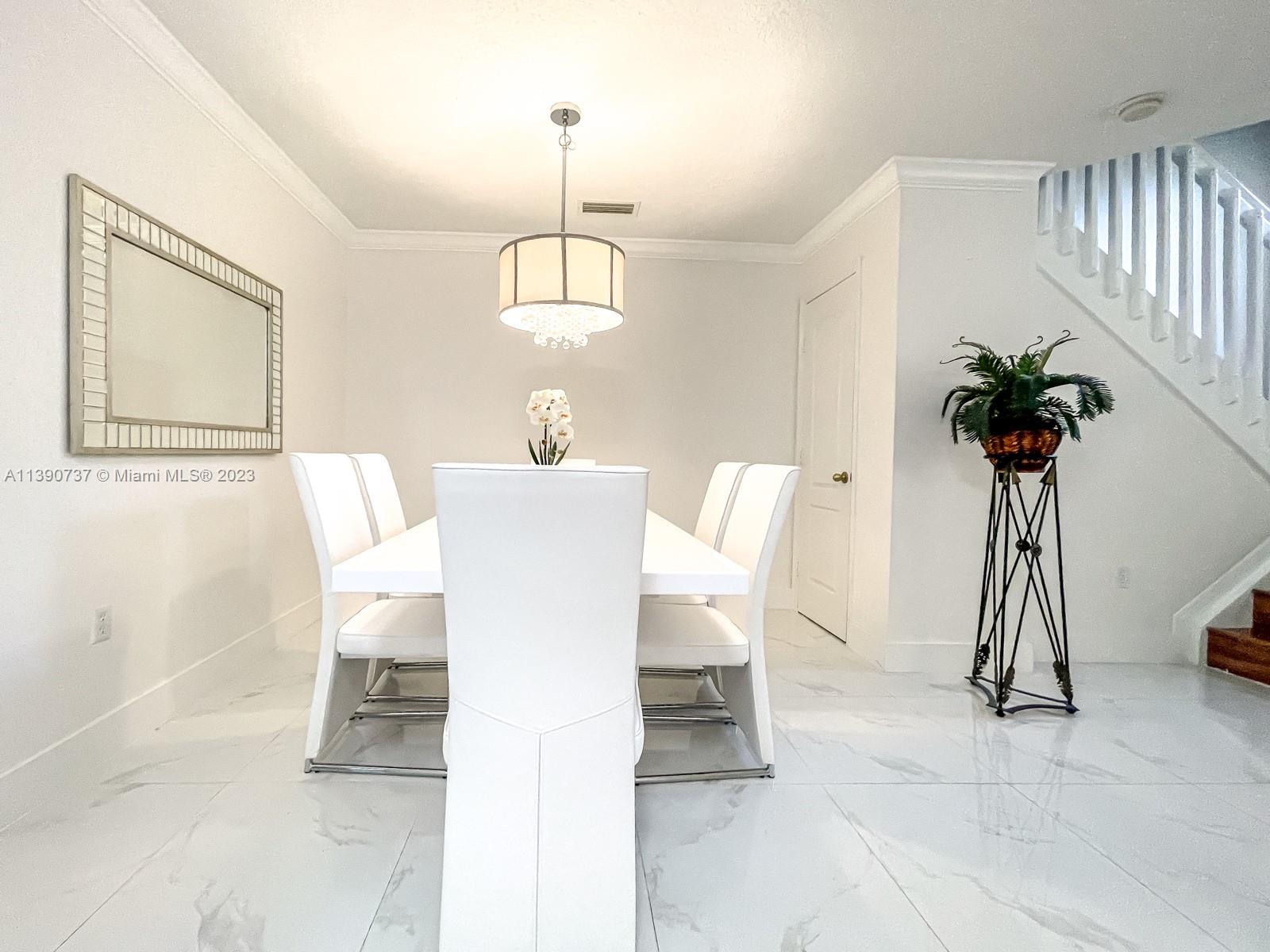3136 Southwest 129th Way, Unit 157 Miramar, FL 33027 - Photo 4 of 23 a view of a dining room with furniture and a chandelier