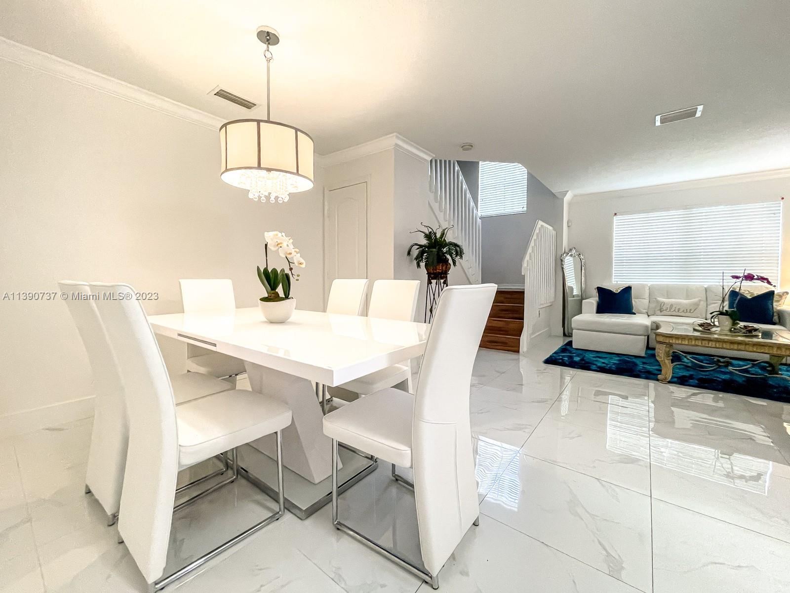 3136 Southwest 129th Way, Unit 157 Miramar, FL 33027 - Photo 5 of 23 a view of a dining room with furniture