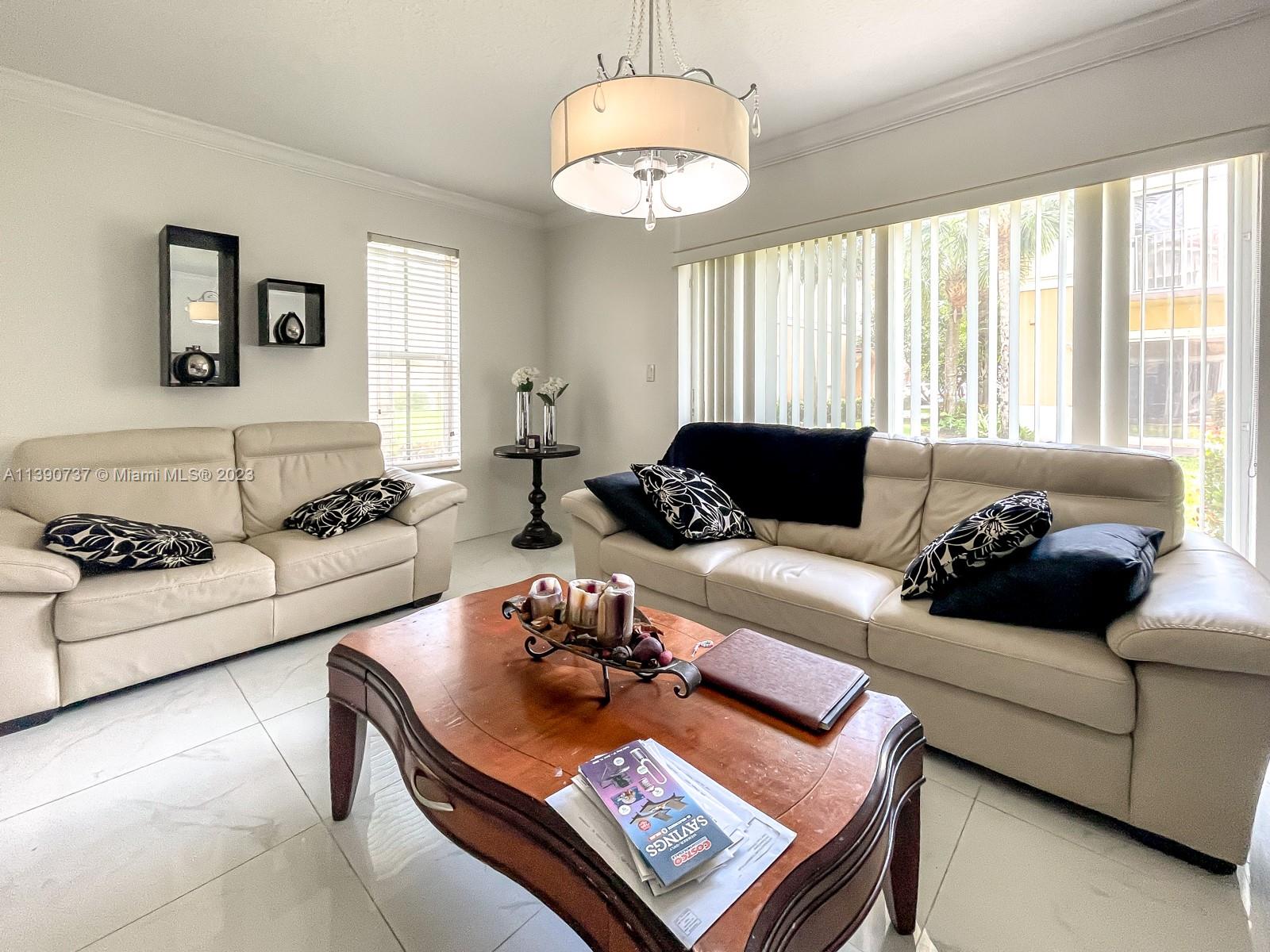 3136 Southwest 129th Way, Unit 157 Miramar, FL 33027 - Photo 6 of 23 a living room with furniture and a large window