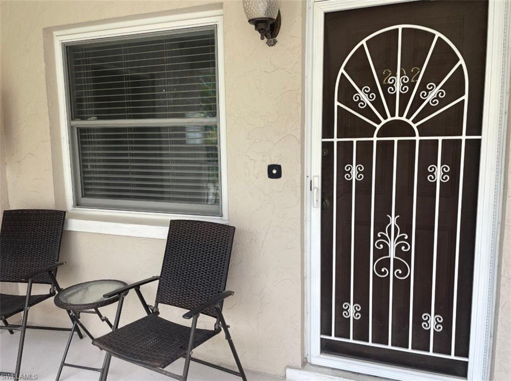 940 3rd Street South, Unit 202 Naples, FL 34102 - Photo 2 of 9 a front view of a house with gym equipment