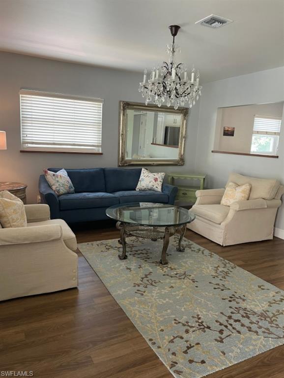 940 3rd Street South, Unit 202 Naples, FL 34102 - Photo 4 of 9 a living room with furniture and a chandelier