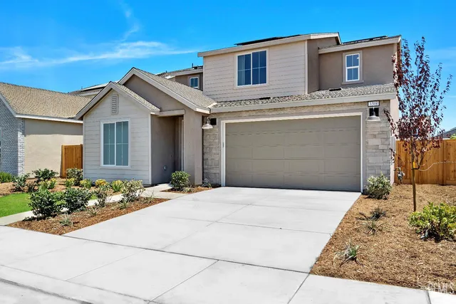 a front view of a house with garage
