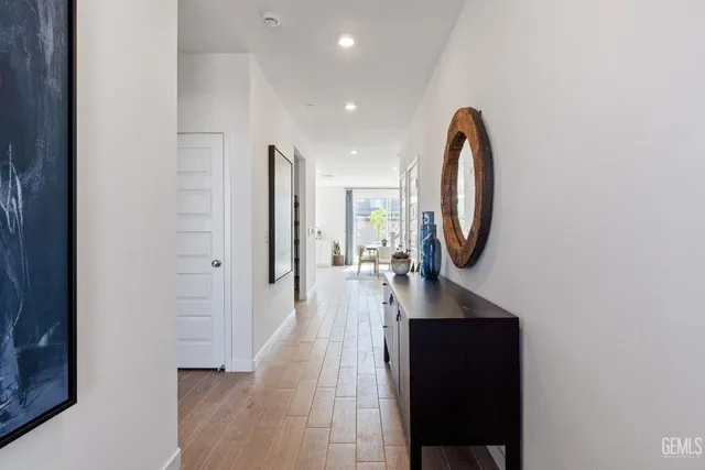 a view of a hallway with wooden floor and entryway