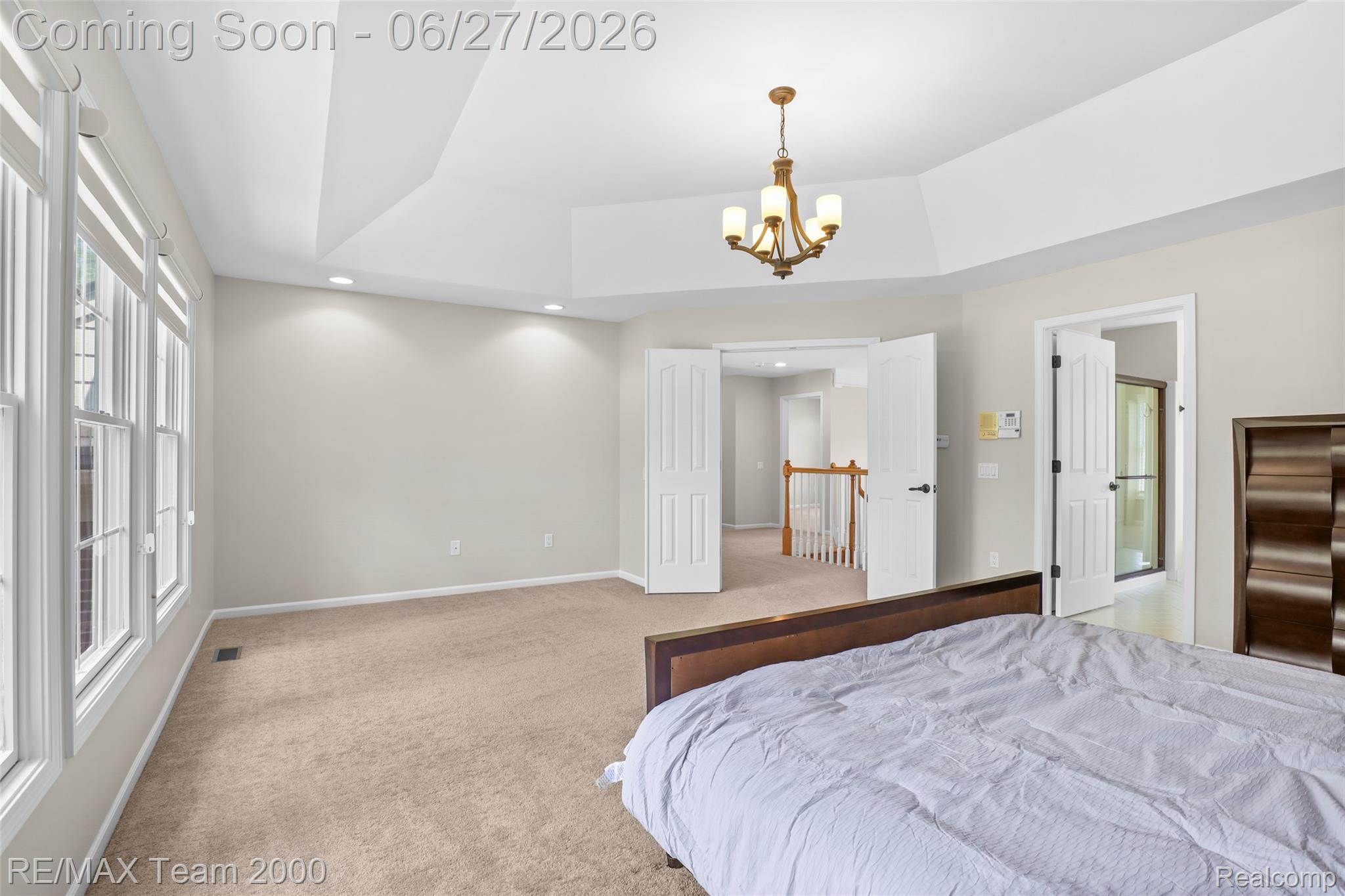 1248 Lasalle Road Canton, MI 48187 - Photo 54 of 67 Spacious room featuring a tray ceiling with a chandelier, recessed lighting, carpet flooring, a wall of windows, and double interior doors