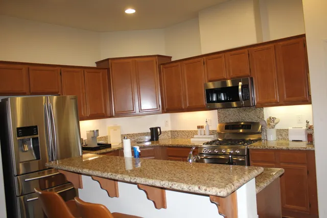 a kitchen with a refrigerator stove top oven a sink and dishwasher