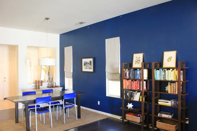 a view of a livingroom with furniture and floor to ceiling window
