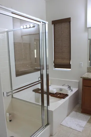 a bathroom with a tub and a shower