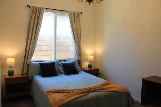 a bedroom with a bed and a window