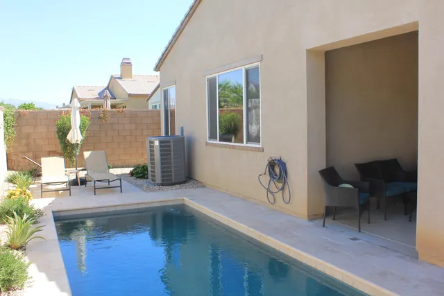 a view of an outdoor sitting area with furniture and umbrella