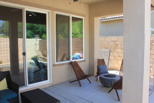 a bedroom with a bed and a lamp next to a window