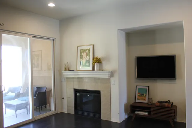 a living room with a fireplace and a flat screen tv
