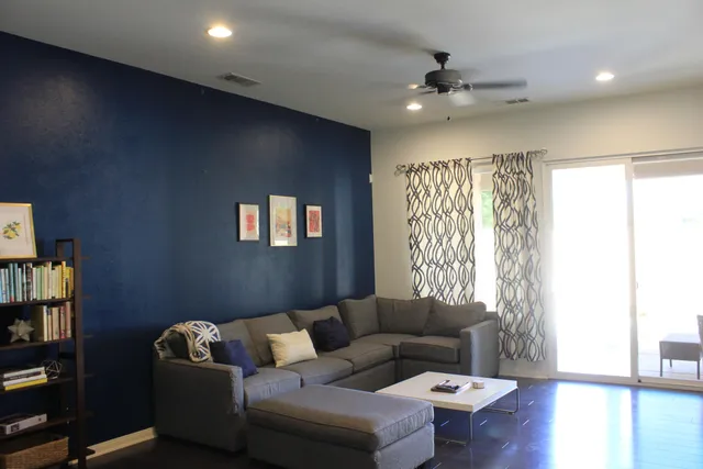 a living room with furniture and a wooden floor