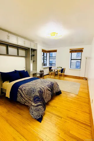 a spacious bedroom with a bed and a lamp