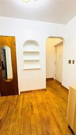 a view of a room with wooden floor
