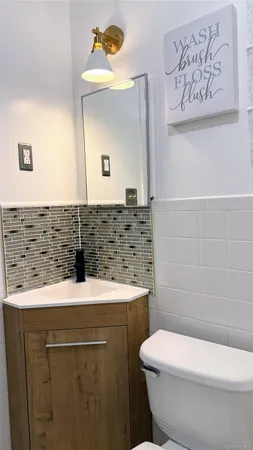 a bathroom with a sink toilet and mirror
