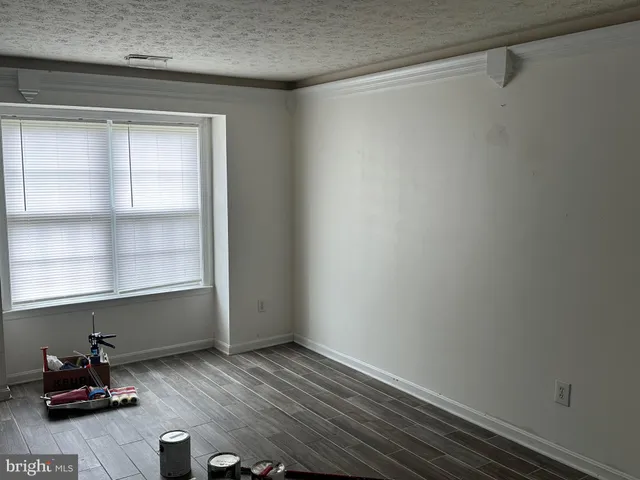 a room with a window and flowerpot