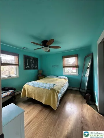 a bedroom with a bed mirror and a window
