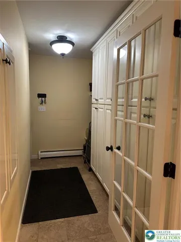 a view of a closet area with wooden floor