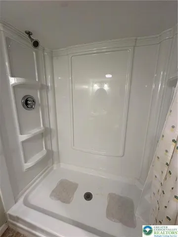 a large room with a lot of window and a wooden floor