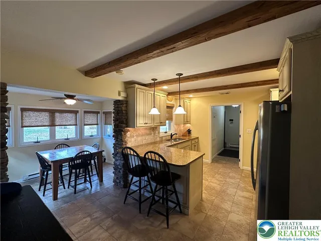 a dining room with furniture and window