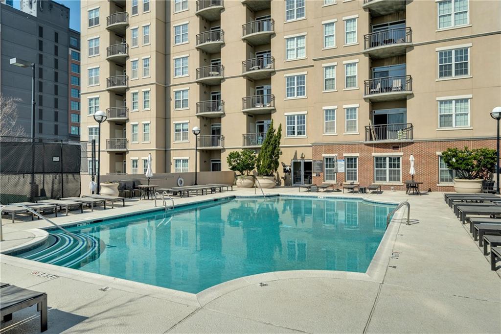 325 East Paces Ferry Road Northeast, Unit 601 Atlanta, GA 30305 - Photo 19 of 28 a swimming pool with outdoor seating and yard