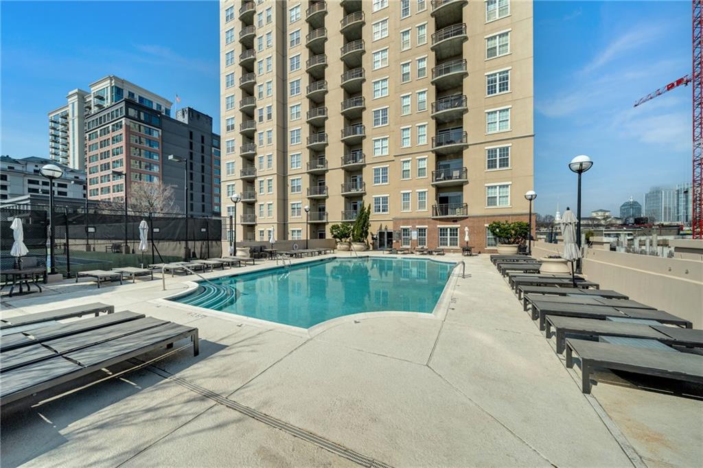 325 East Paces Ferry Road Northeast, Unit 601 Atlanta, GA 30305 - Photo 20 of 28 a view of a swimming pool with a lounge chairs