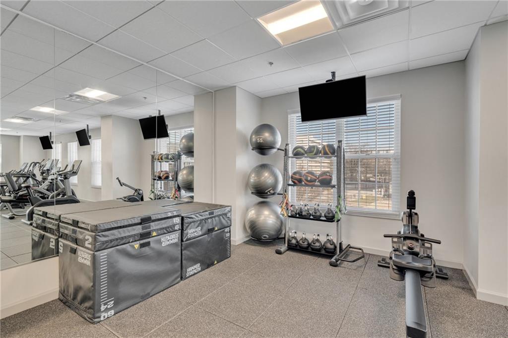 325 East Paces Ferry Road Northeast, Unit 601 Atlanta, GA 30305 - Photo 26 of 28 a room with gym equipment and flat screen tv