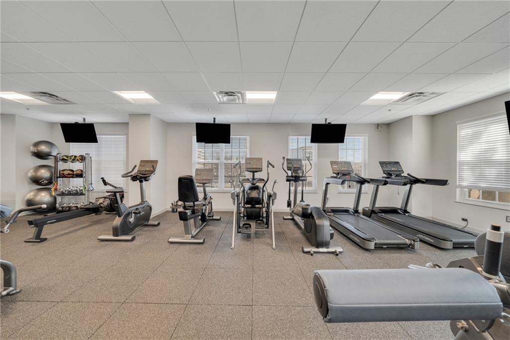 325 East Paces Ferry Road Northeast, Unit 601 Atlanta, GA 30305 - Photo 27 of 28 a room with gym equipment and a large window