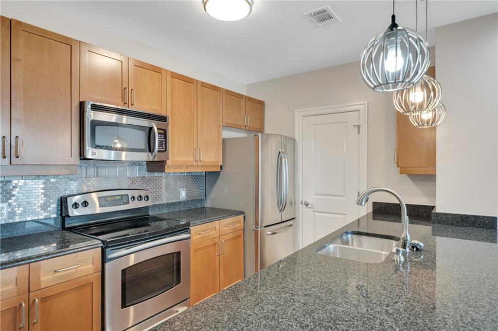 325 East Paces Ferry Road Northeast, Unit 601 Atlanta, GA 30305 - Photo 5 of 28 a kitchen with a sink appliances and cabinets