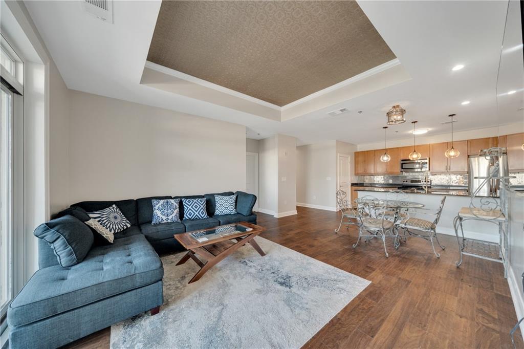 325 East Paces Ferry Road Northeast, Unit 601 Atlanta, GA 30305 - Photo 7 of 28 a living room with furniture and view of kitchen