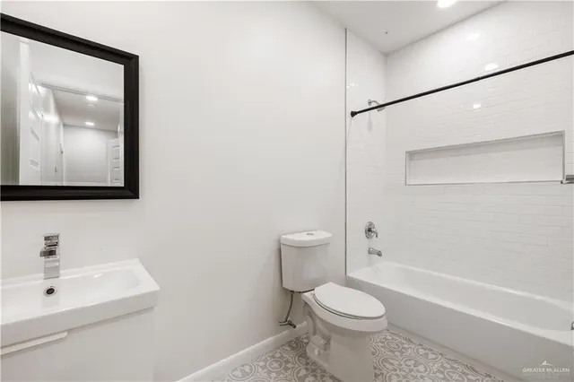 a white toilet sitting next to a bathroom sink