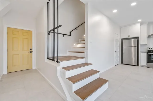 a view of entryway with wooden floor and white walls