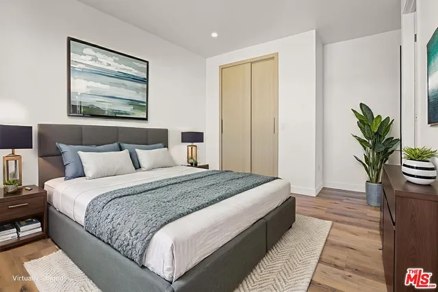 a bedroom with bed and a potted plant