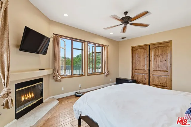 a bedroom with a bed and a fireplace