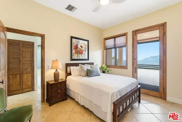 a bedroom with a bed and a large window