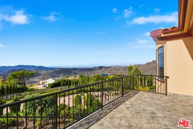 a view of balcony with furniture