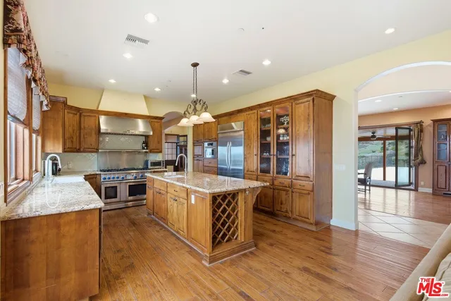 a kitchen with stainless steel appliances granite countertop a stove and refrigerator