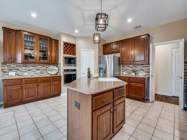 a kitchen with stainless steel appliances granite countertop a stove and refrigerator
