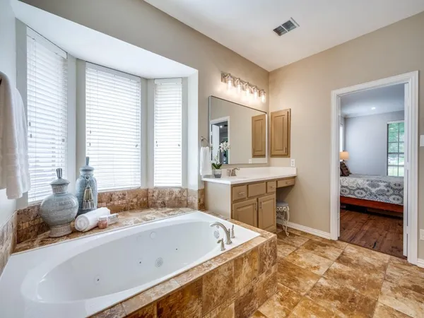 a spacious bathroom with sink shower and bathtub