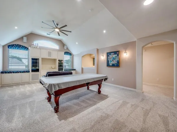a room with pool table and windows