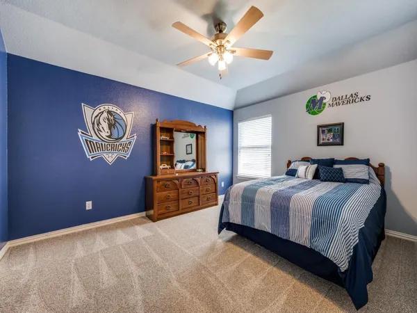 a spacious bedroom with a bed and a chandelier