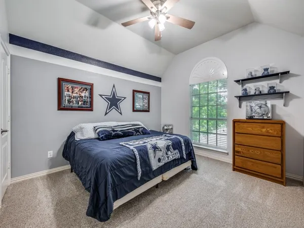 a bedroom with a bed and a chandelier